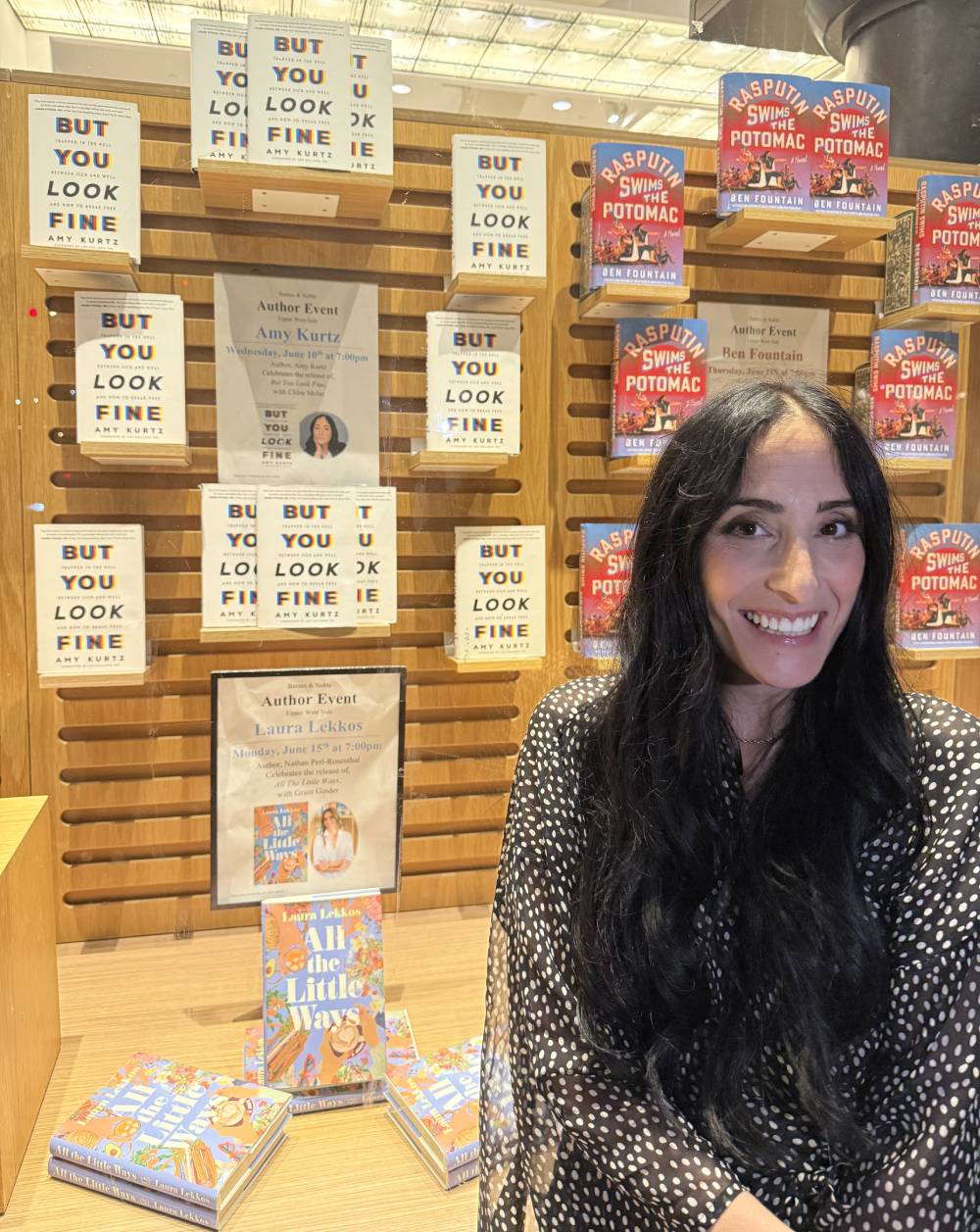 Amy Kurtz Standing In Front of Her Book Display