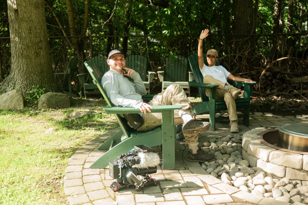 Documentary director Reece Robinson sitting with Researcher Monica Cipriani in Rich Johannesen's back yard.