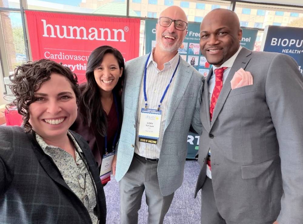 Tick Boot Camp at ILADS 2026: Official Podcast & Gala Emcees 15 Drs. Melanie Stein, Vy Simeles, Cory Tichauer, and Chris Winfrey in the ILADS exhibit area.
