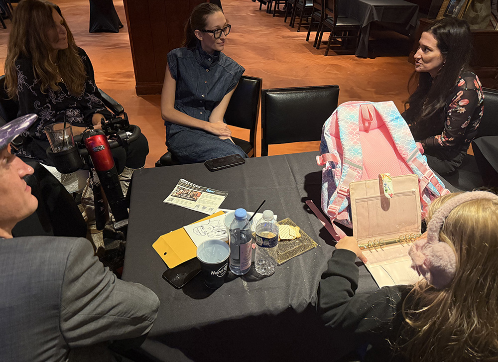 Tick Boot Camp giveaway recipients connecting at a table during GLA First Round in New York City