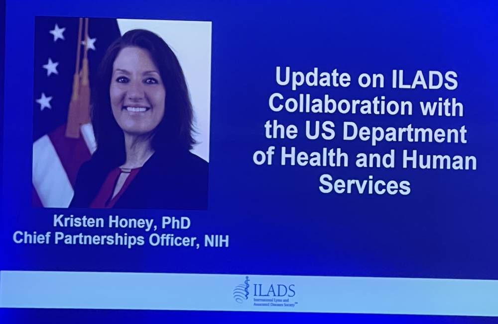 Tick Boot Camp at ILADS 2026: Official Podcast & Gala Emcees 17 Kristen Honey’s presentation slide about the ILADS collaboration with the U.S. Department of Health and Human Services.
