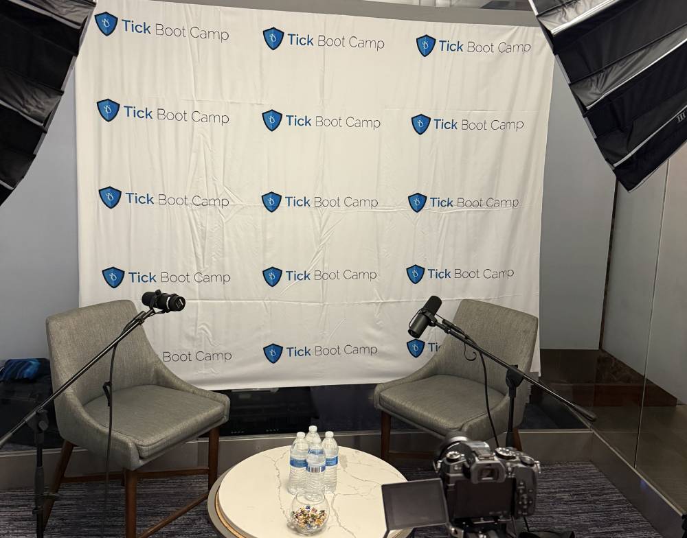 Tick Boot Camp at ILADS 2026: Official Podcast & Gala Emcees 1 Tick Boot Camp’s official ILADS 2026 podcast studio with microphones, lighting, and a branded backdrop.